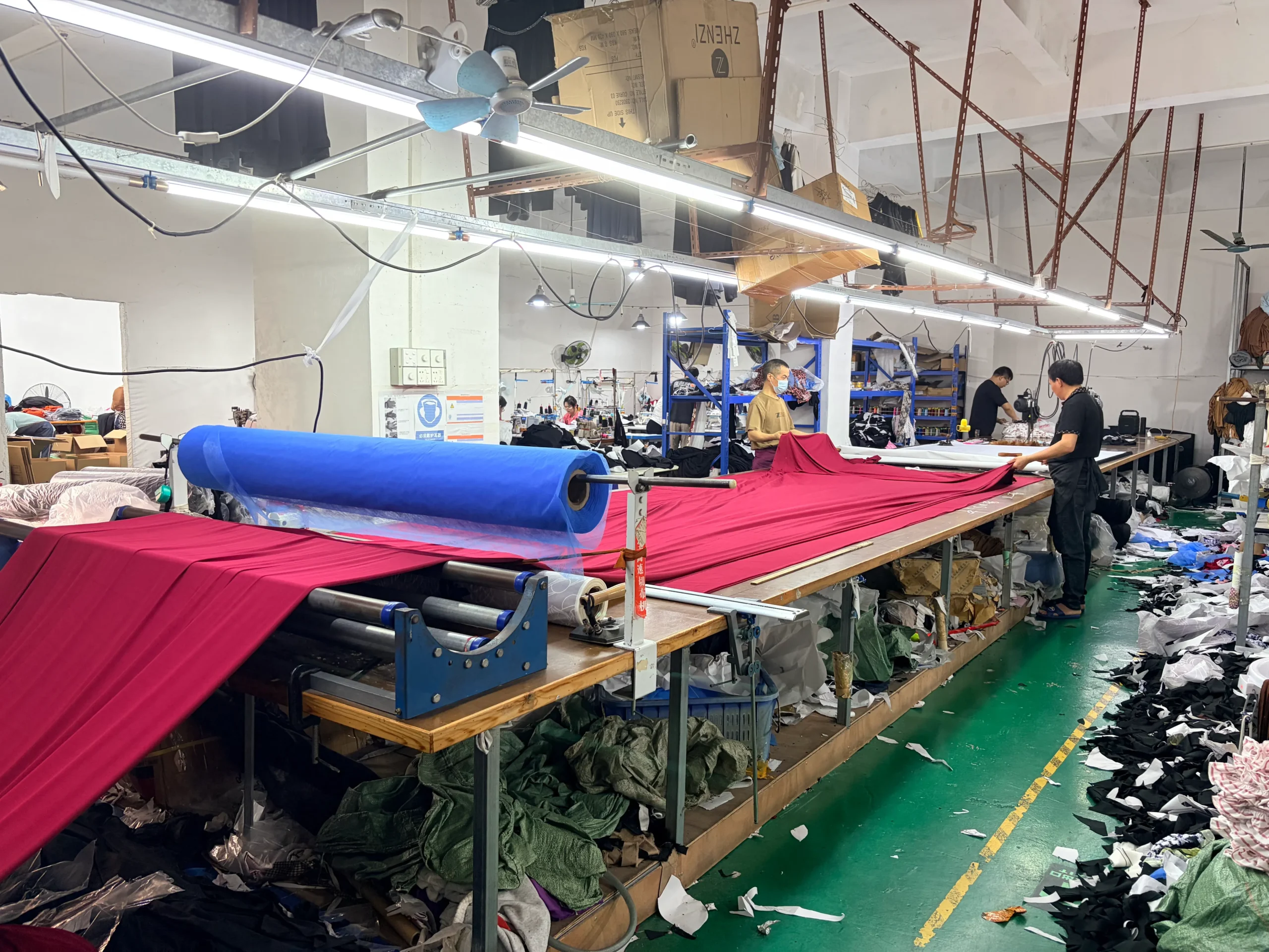 Fabric spreading and cutting process in garment factory