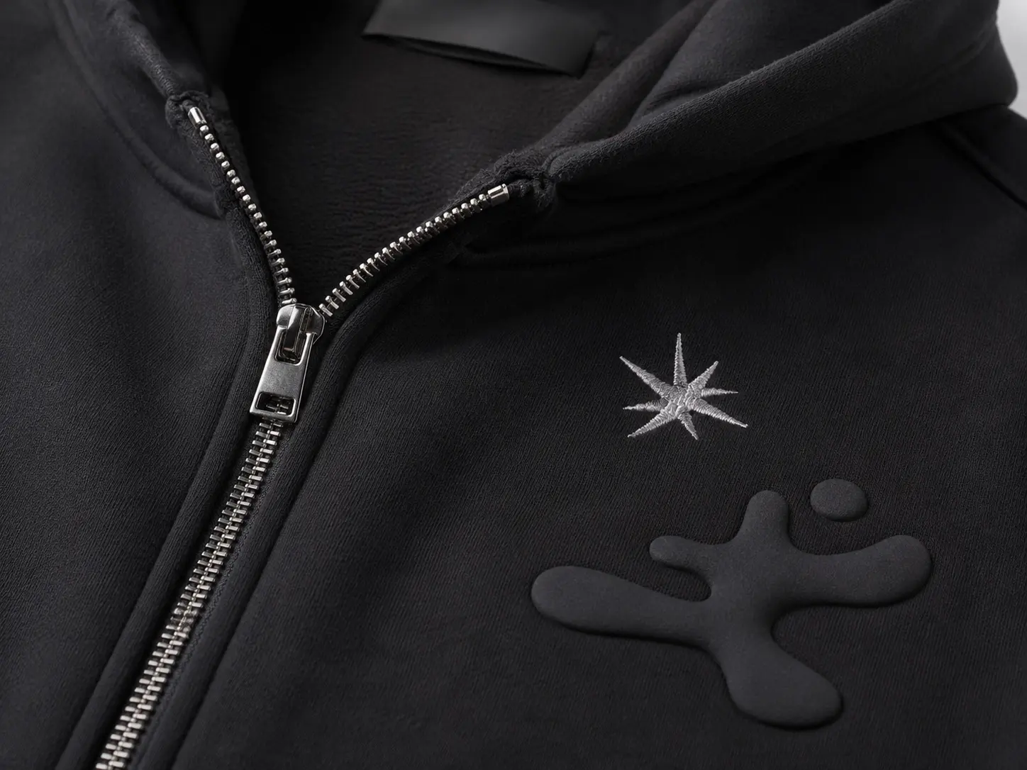 Embroidery and puff print detail on custom zip-up hoodie