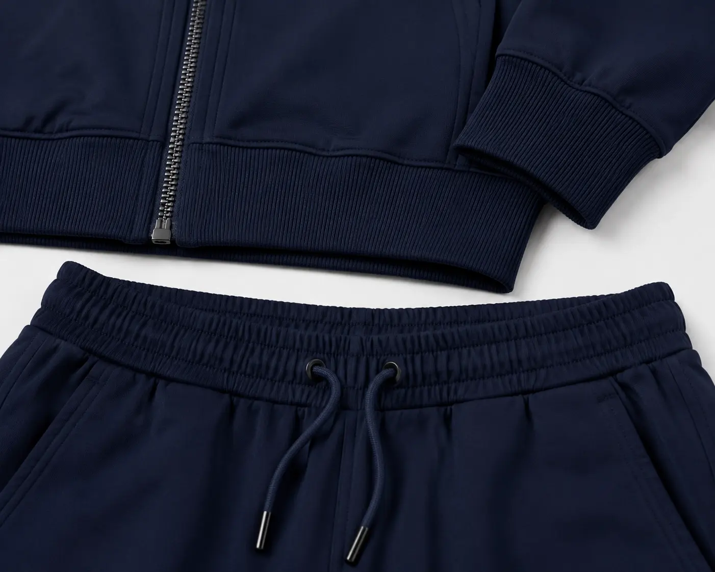 Rib cuff hem and waistband coordination detail for zip-up tracksuit