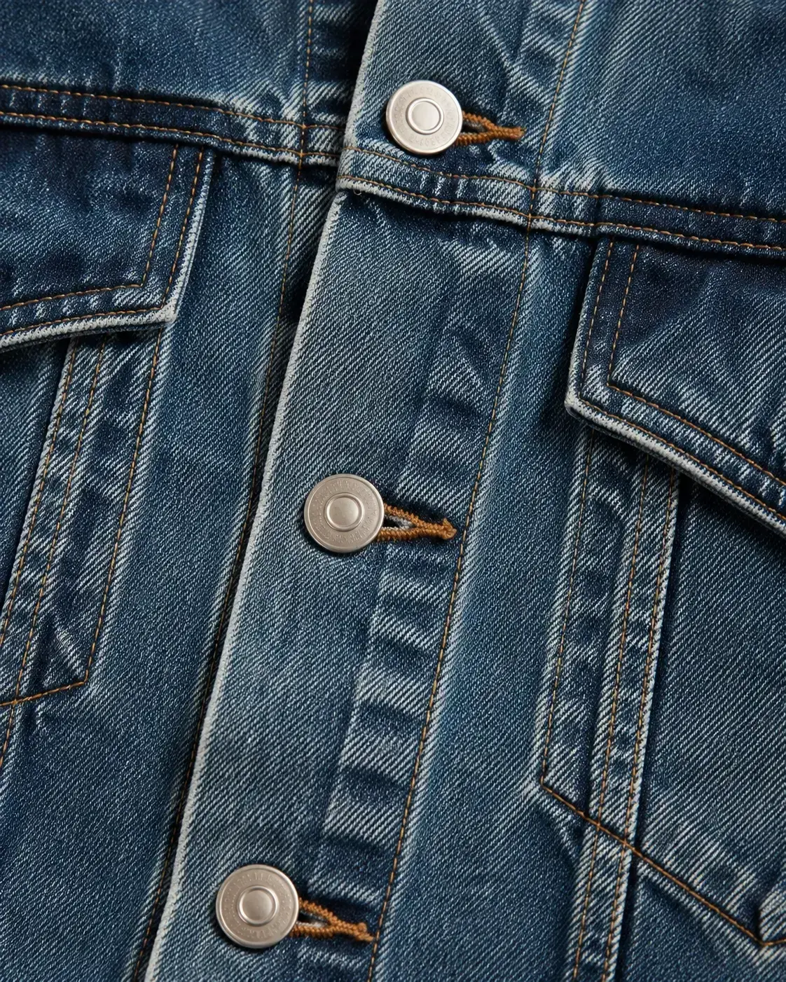 Metal button hardware detail for custom denim jackets