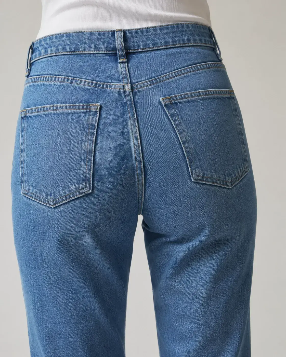 Back pocket placement for custom denim jeans